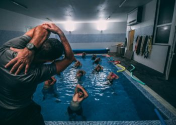 people stretching inside pool room