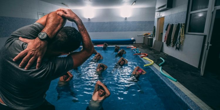 people stretching inside pool room